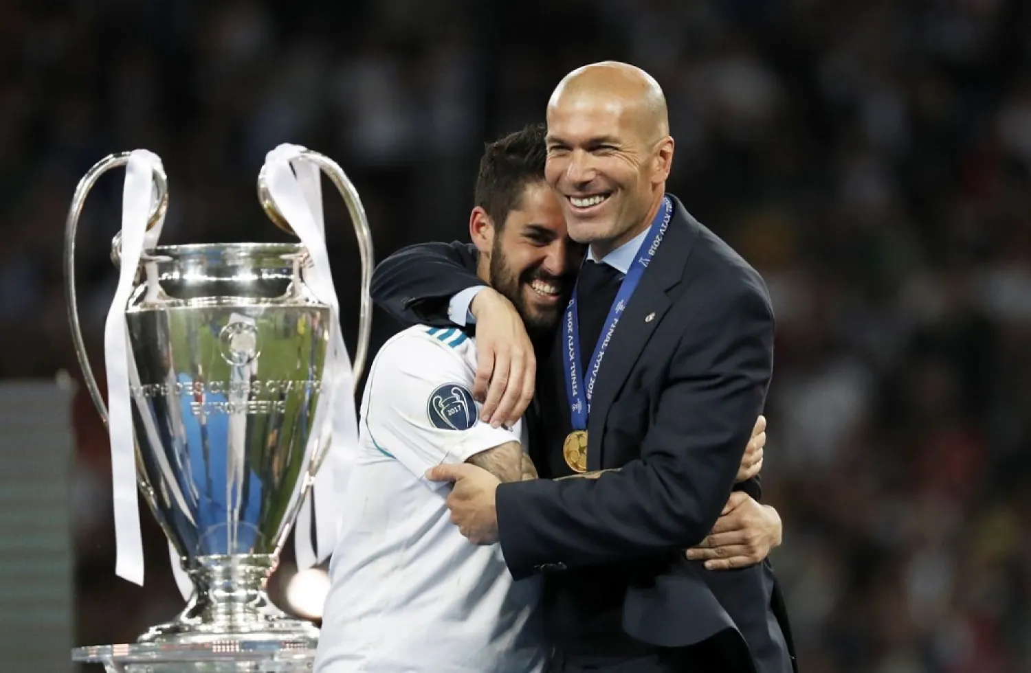 Real Madrid's Isco hugs coach Zinedine Zidane after winning the Champions League Final against Liverpool. (AP)