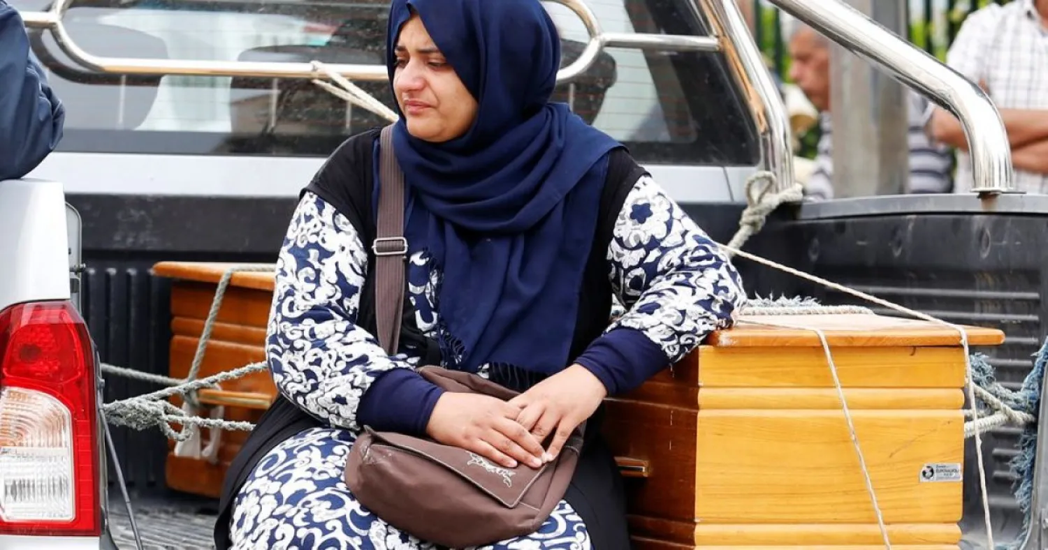 A relative of Tunisian migrants, who drowned when their boat sank, waits outside a hospital morgue to identify the bodies of her kin in Sfax, Tunisia June 4, 2018. (Reuters)