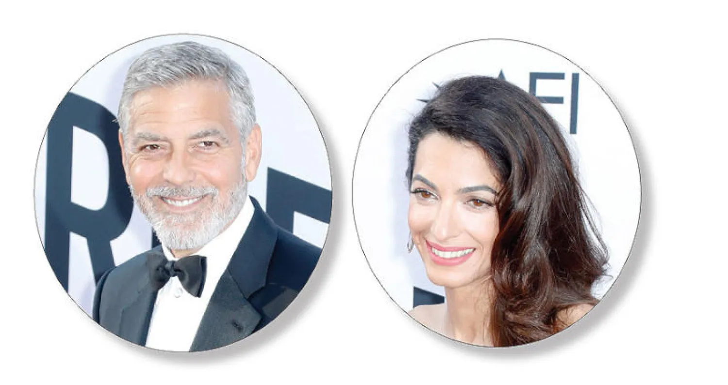 جورج وأمل كلوني لدى وصولهما إلى حفل تكريمه (إ.ب.أ)