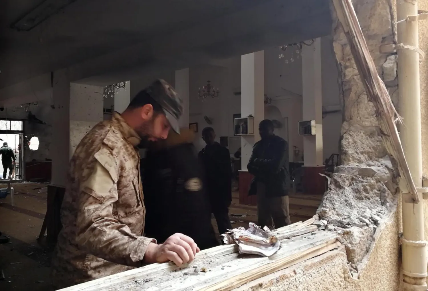 A member of the Libyan National Army inspects the damage following a twin bombing inside a mosque in Benghazi, Libya February 9, 2018. REUTERS /Stringer