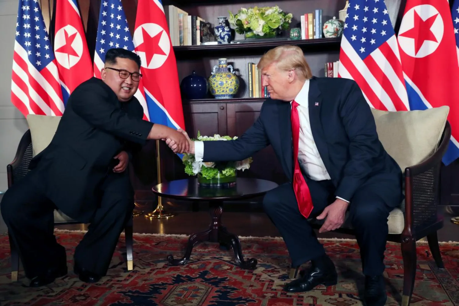 US President Donald Trump shakes hands with North Korea's leader Kim Jong Un before their bilateral meeting at the Capella Hotel on Sentosa island in Singapore June 12, 2018. (Reuters)