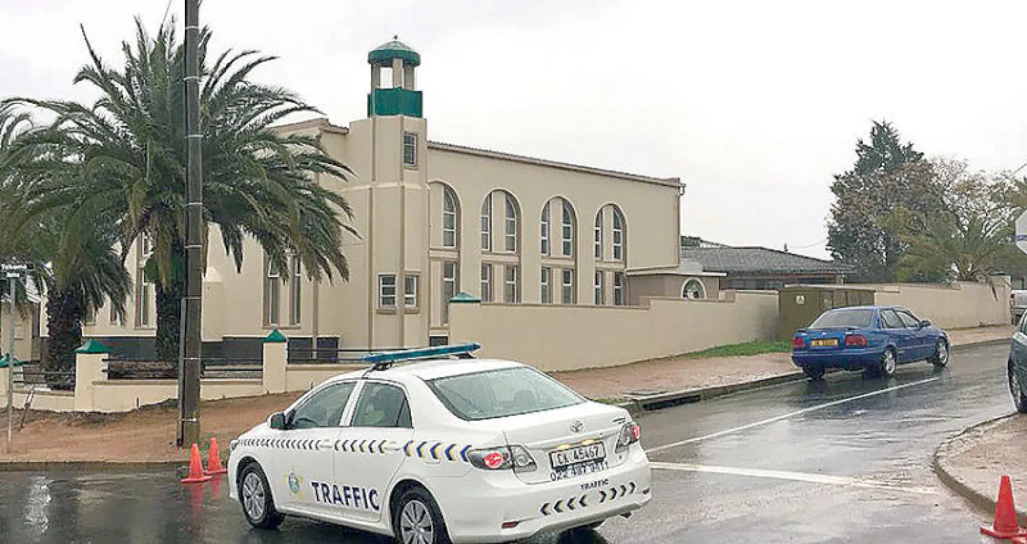 سيارة شرطة أمام مسجد مالزبري في جنوب أفريقيا عقب هجوم الطعن أمس (أ.ف.ب)