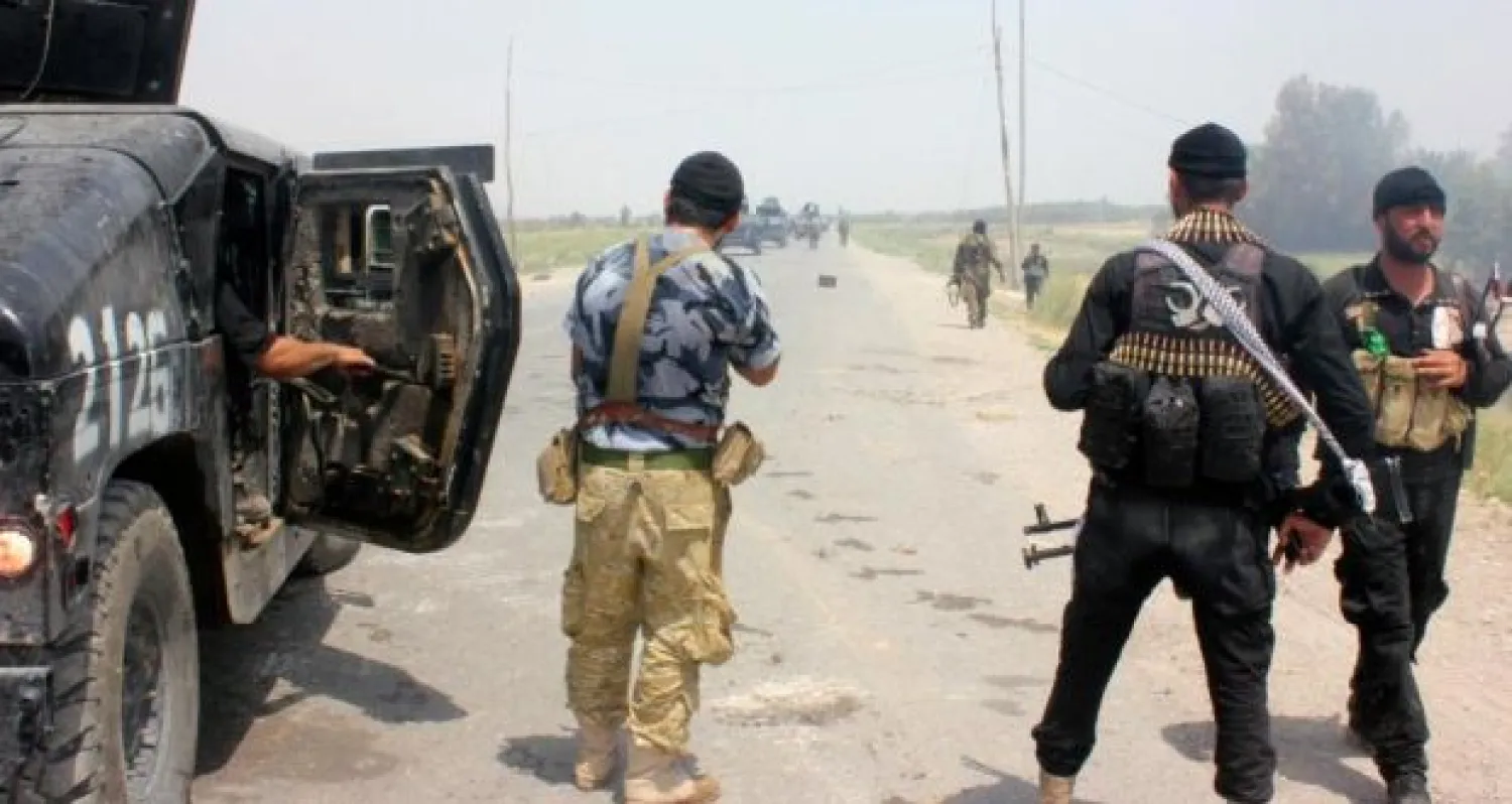 Iraqi security forces and armed volunteers move with military vehicles during clashes with ISIS militants in the town of Dalli Abbas in Diyala province. Reuters