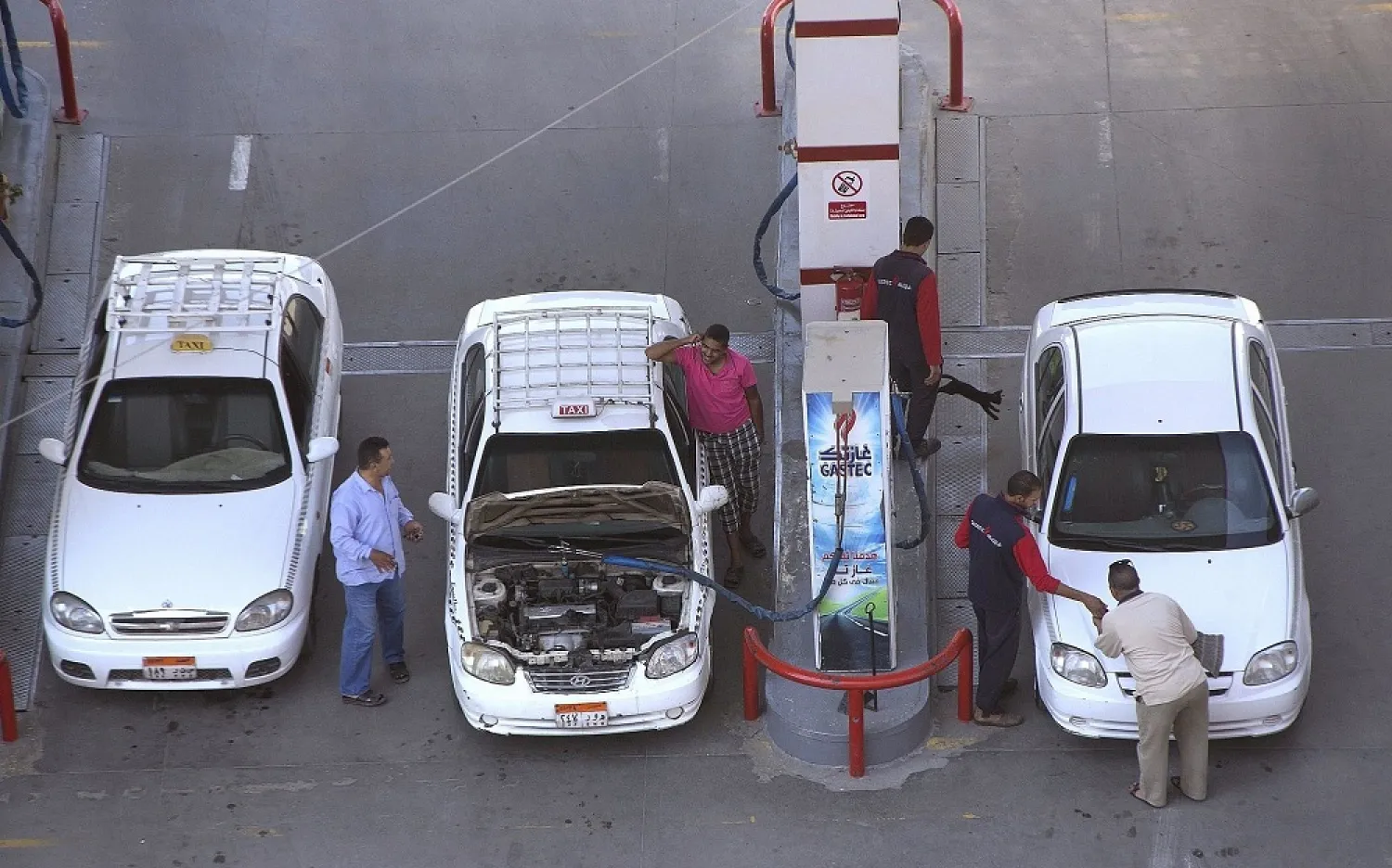 In this June 29, 2017, file photo, taxi drivers chat as they refuel their vehicles at a gas station in Cairo, Egypt. (AP)
