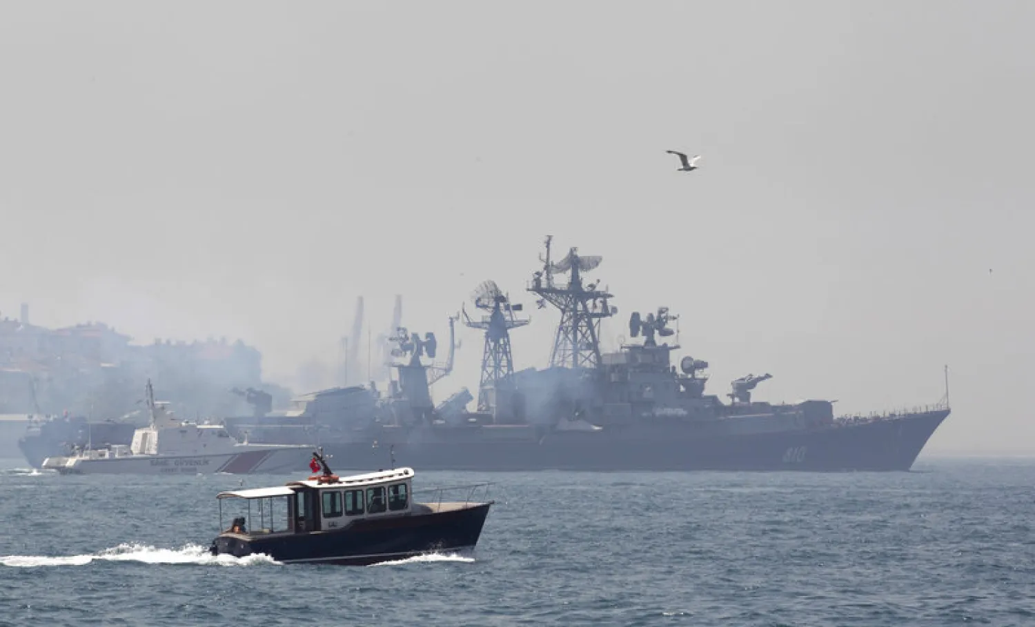 A Turkish boat (in the foreground) escorts the Russian naval destroyer Smetlivy, in the Bosphorus in Istanbul, in July 2012. (Reuters)