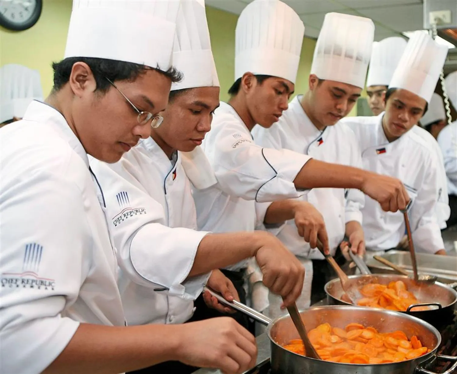Students cook vegetables during a class at a culinary school in Manila. (Reuters)