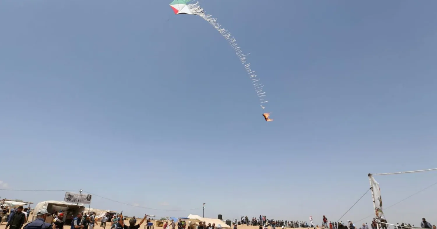 Palestinian demonstrators fly a flaming kite toward the Israeli side during a protest at the Israel-Gaza border, southern Gaza Strip. (Reuters)