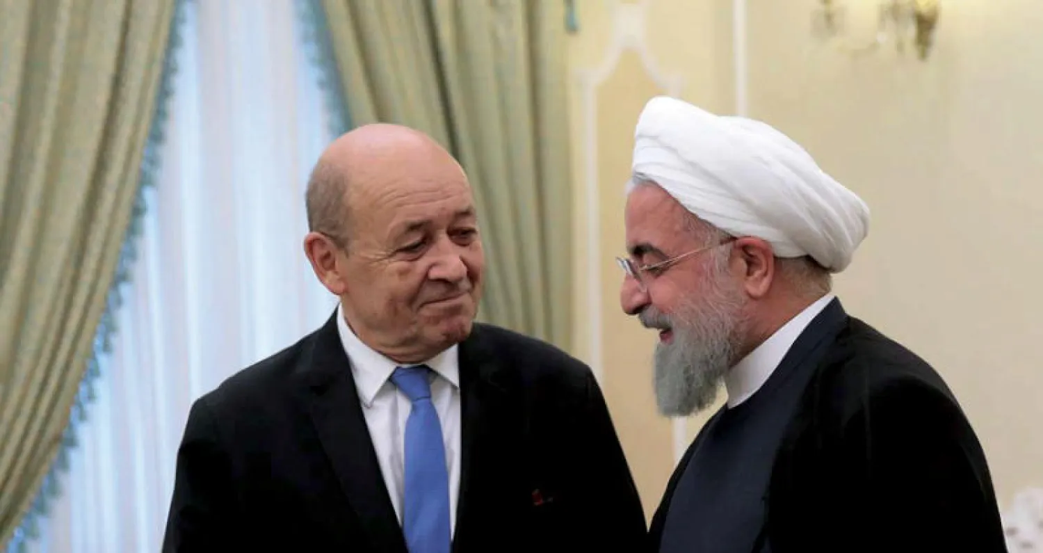 وزیر الخارجیة الفرنسي جان إيف لودريان والرئيس الإيراني حسن روحاني خلال لقائهما في طهران بداية مارس الماضي (إرنا)