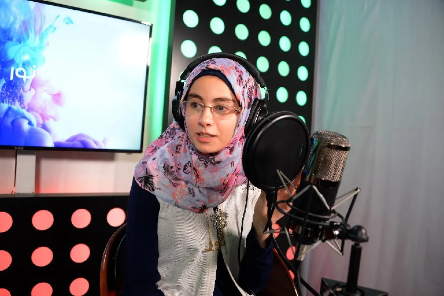 Radio presenter Nour Tai broadcasts her weekly programme on One FM, a radio station in the northern Iraqi city of Mosul, on June 1, 2018. Zaid AL-OBEIDI / AFP