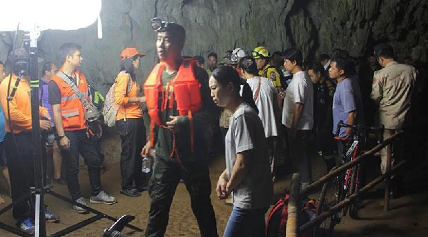 رجال إنقاذ ومتطوعون أمام الكهف (صحيفة بانكوك بوست)