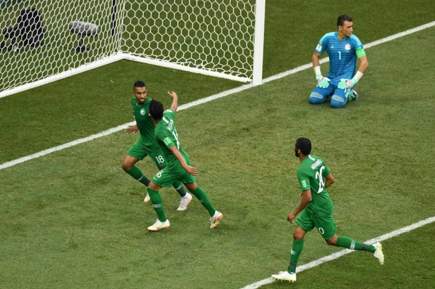 Saudi players celebrate after scoring the winning goal against Egypt. (AFP)