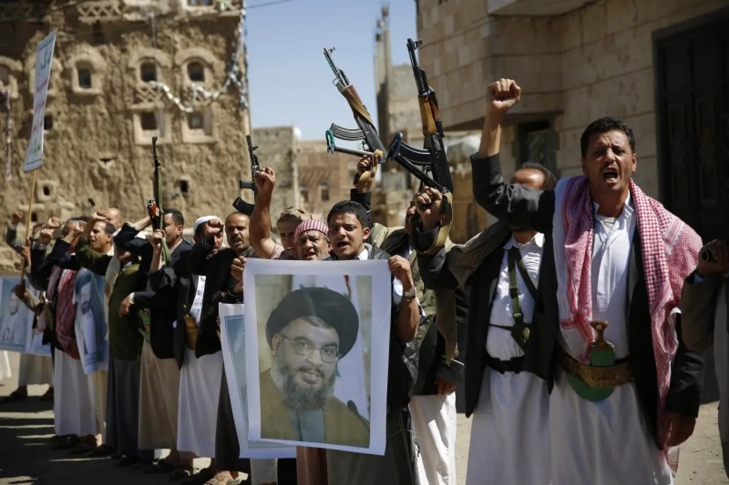 In this March 3, 2016 photo, Houthis, hold a poster of Hezbollah leader Hassan Nasrallah during a rally in support of Hezbollah, in Sanaa, Yemen. (AP Photo/Hani Mohammed, File)
