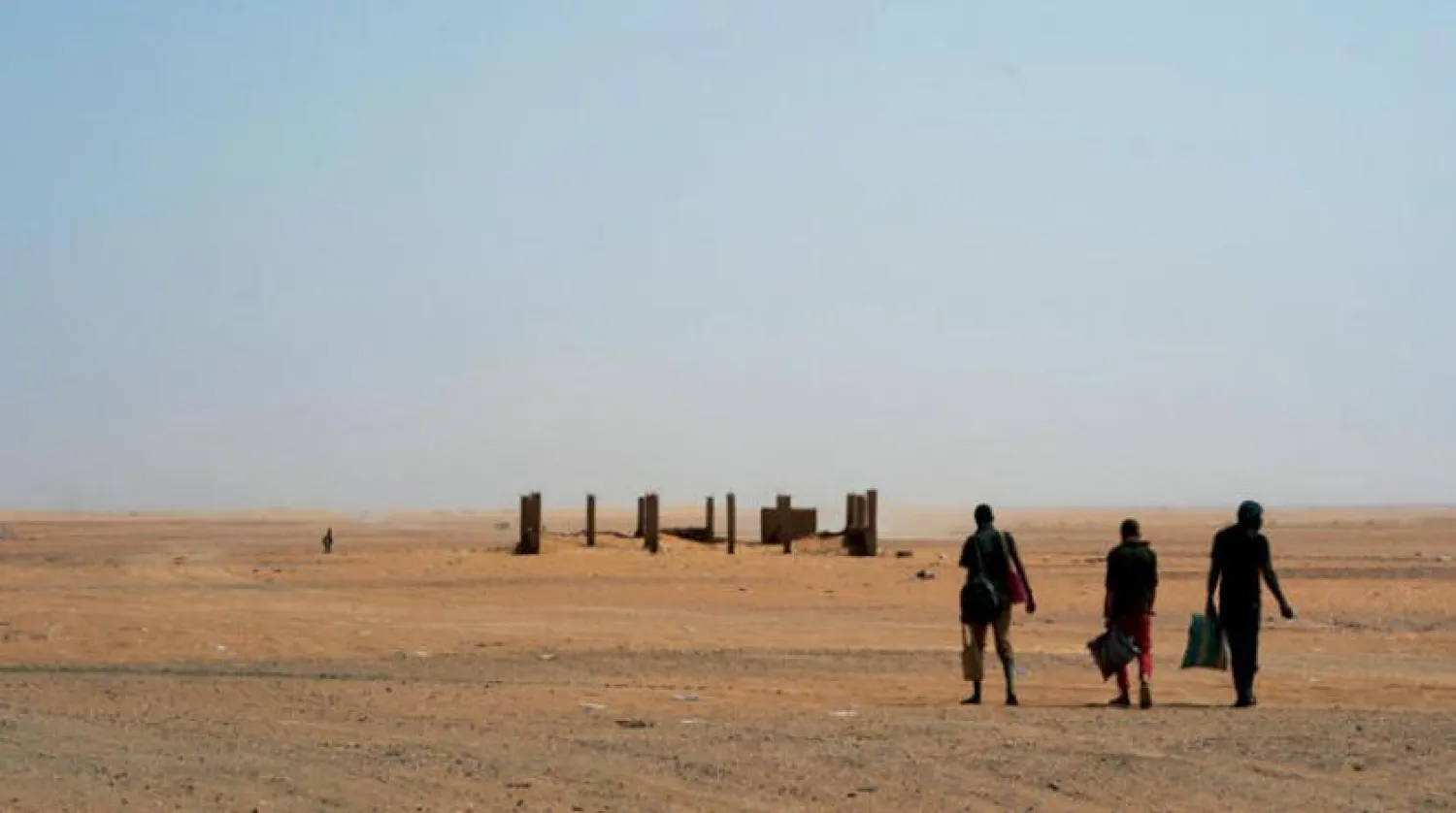 Three men head north towards Algeria after crossing the Assamaka border post in northern Niger on Sunday, June 3, 2018. (AP Photo/Jerome Delay)