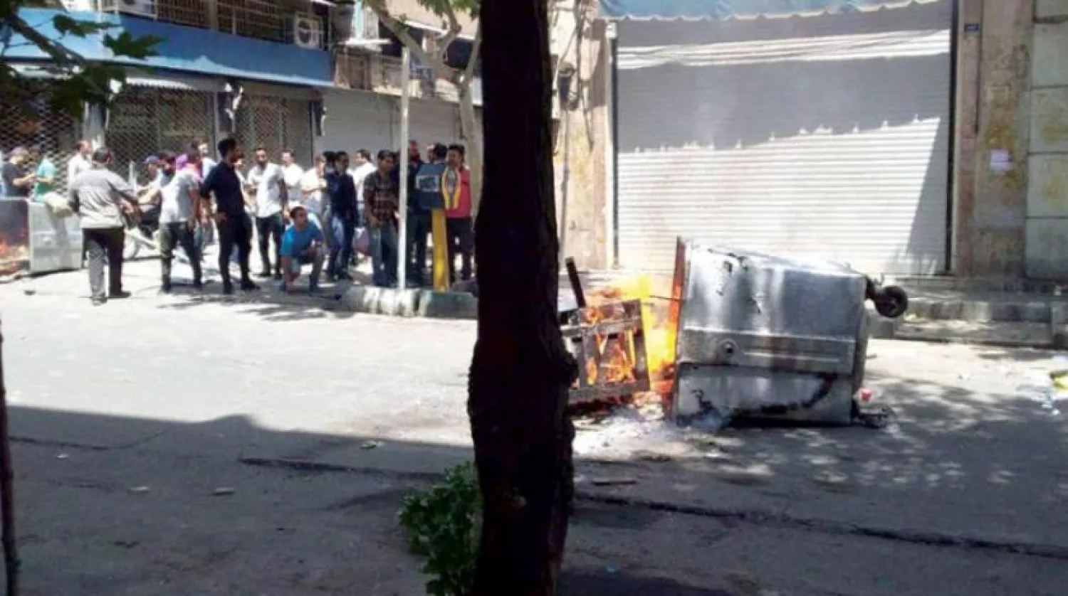 Protesters set fire to garbage dumpsters during rallies in Tehran on Tuesday. (social media)