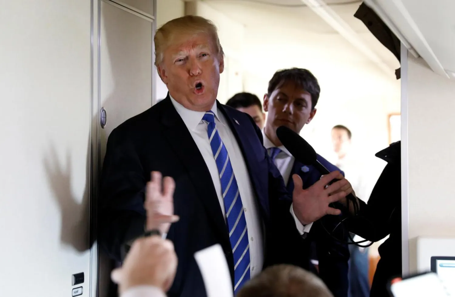 US President Donald Trump speaks to reporters aboard Air Force One after visiting White Sulphur Springs, West Virginia, U.S., April 5, 2018. REUTERS/Kevin Lamarque