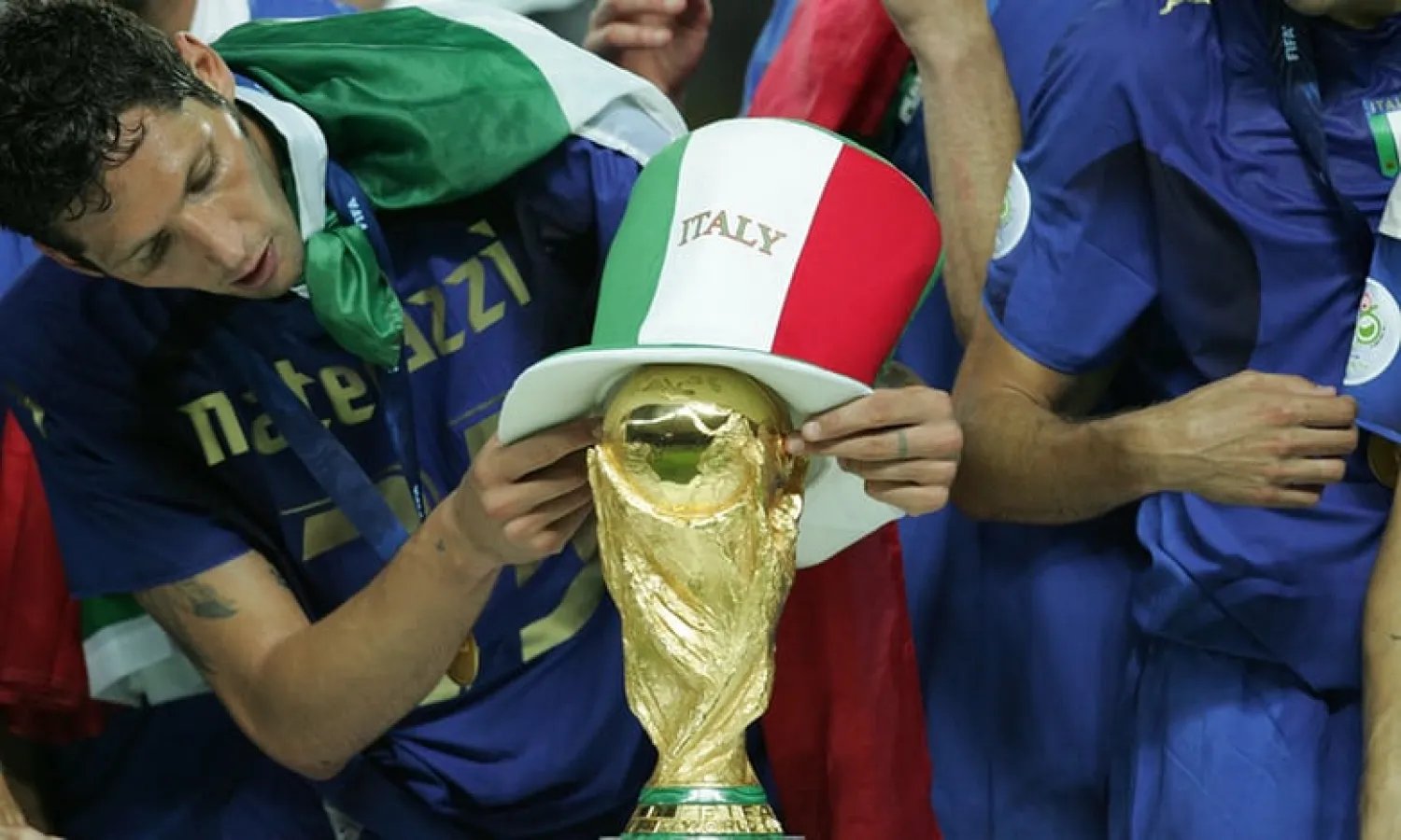 Marco Materazzi places a hat on the World Cup trophy in Berlin in 2006. Photograph: Tom Jenkins for the Guardian
