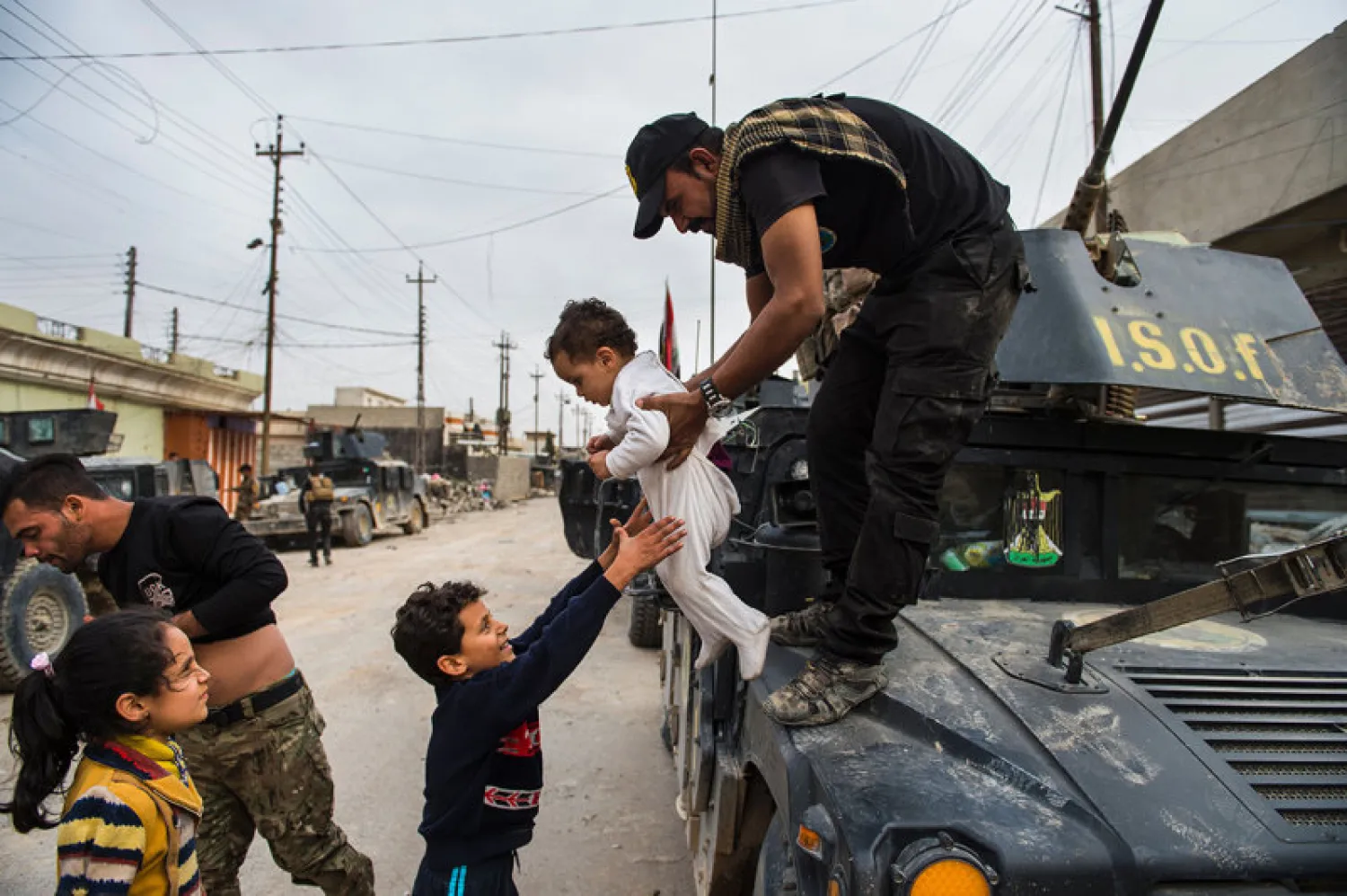 Children emerge from their houses to greet soldier from the Iraqi Special Forces 2nd division during a lull in the fighting with ISIS militants while pushing into the Aden neighbourhood in Mosul. AFP file photo