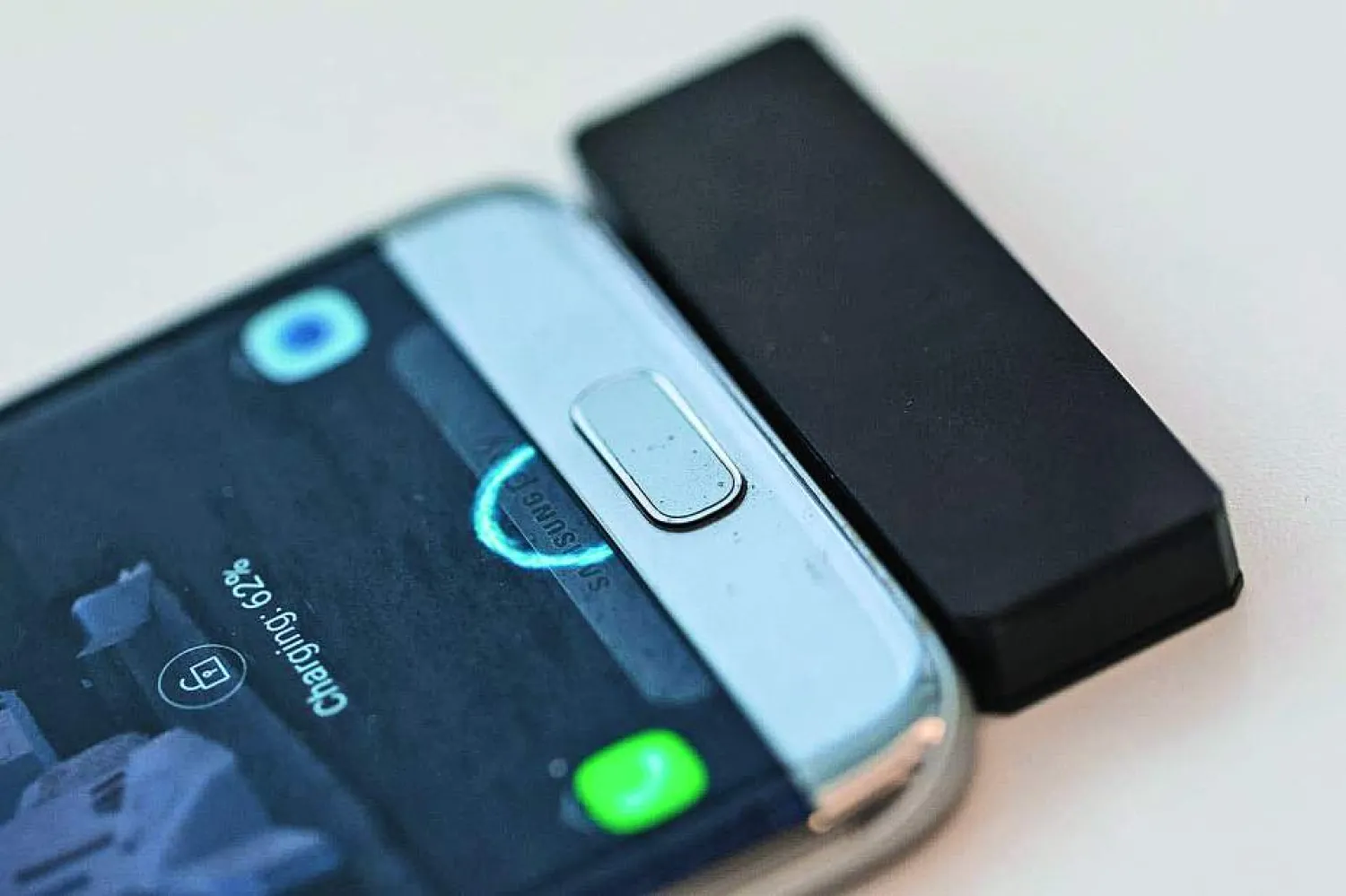 A prototype Wi-Charge adapter let this phone juice up sitting on a table -- without any plugs. (Geoffrey A. Fowler/The Washington Post)
