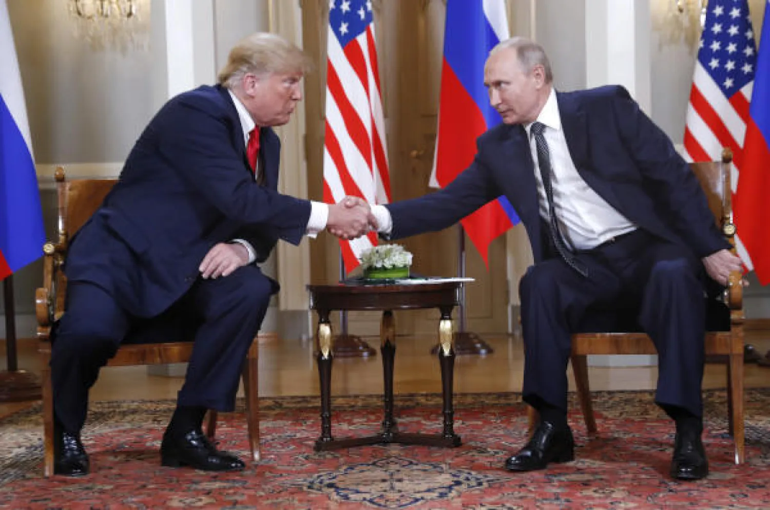 US President Donald Trump, left, and Russian President Vladimir Putin shake hand at the beginning of a meeting at the Presidential Palace in Helsinki, Finland, Monday, July 16, 2018. (AP Photo/Pablo Martinez Monsivais)