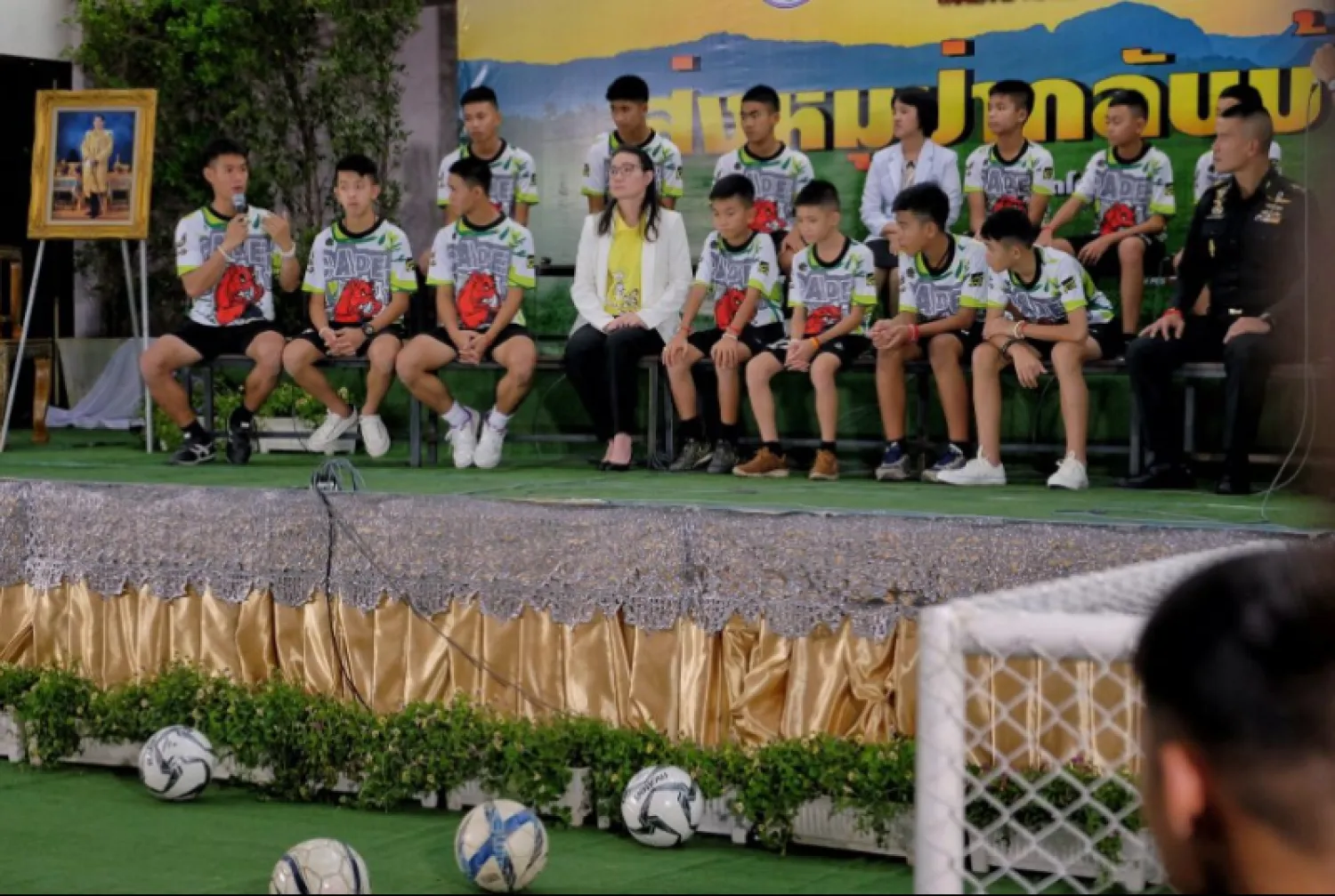 Twelve boys and their coach, Ekkapol Chantawong (Left), from the 'Wild Boars' soccer team speak during a press conference for the first time since they were rescued from a cave in northern Thailand last week, on July 18, 2018 in Chiang Rai, Thailand. (Photo by Linh Pham/Getty Images)