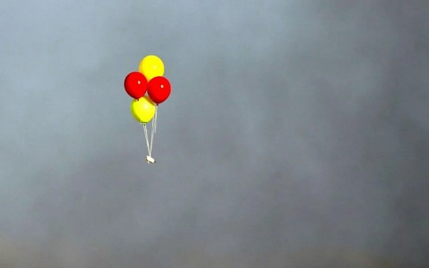 Incendiary balloons are flown towards Israel during clashes along the border between the Gaza Strip and Israel, on July 13, 2018. (AFP Photo/Mahmud Hams)