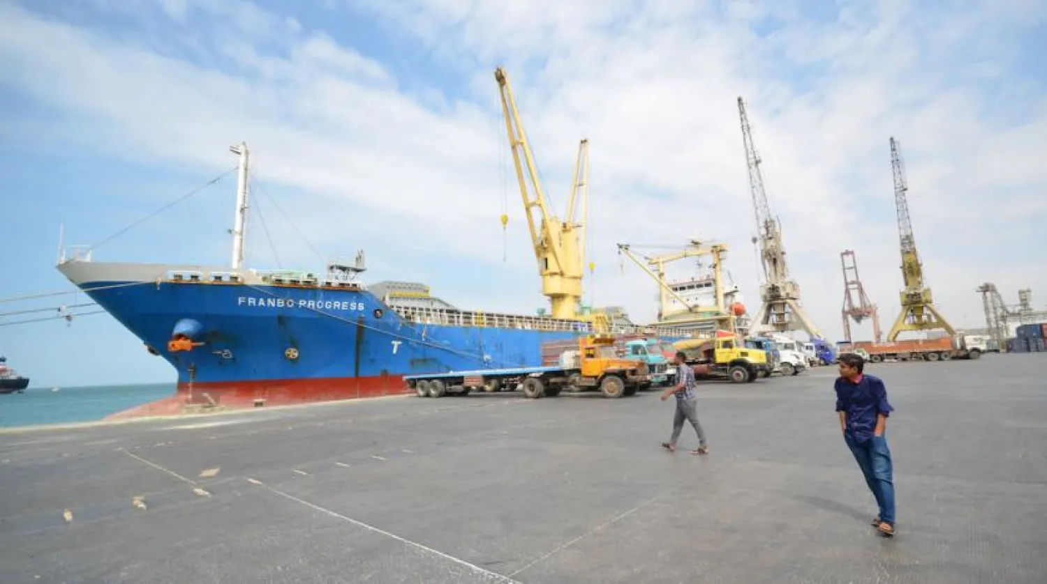 People walk past a ship docked at the Red Sea port of Hodeidah, Yemen. Reuters

 