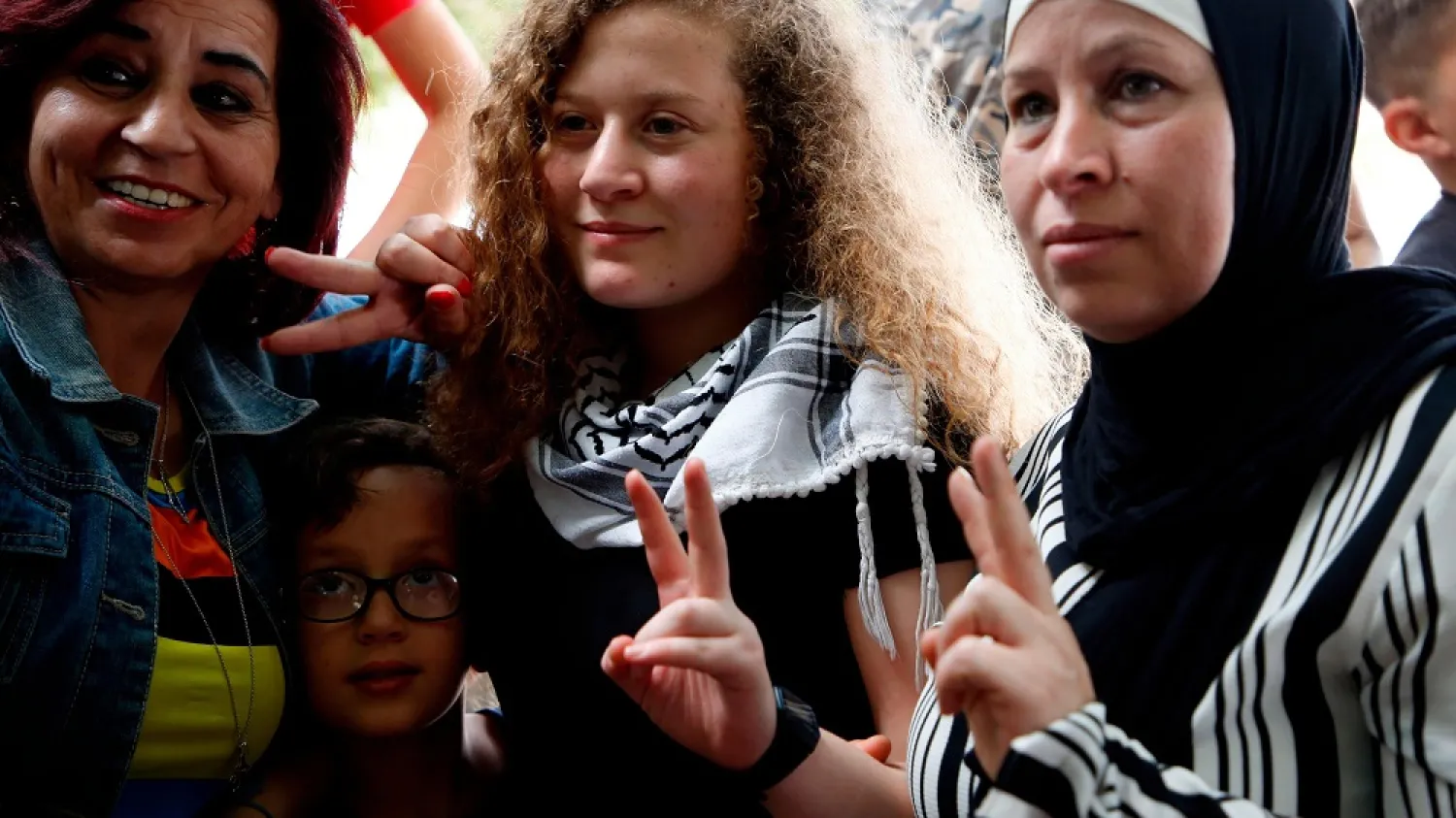 Ahed Tamimi, center spent eight months in prison for slapping Israeli solidiers. (AFP)