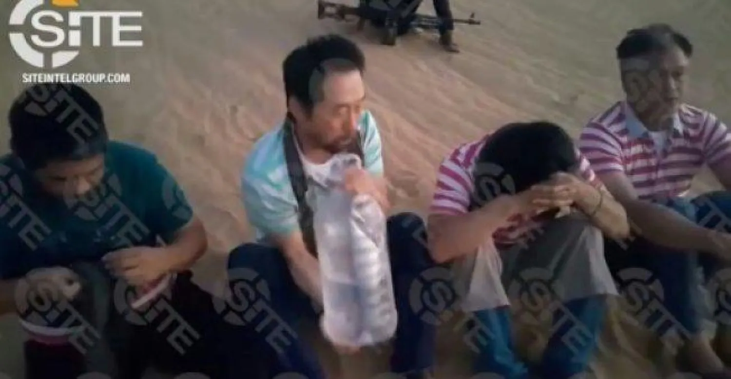 صورة من فيديو نشره موقع «سايت» يظهر 4 رهائن خطفهم مسلحون في طرابس (أ.ف.ب)