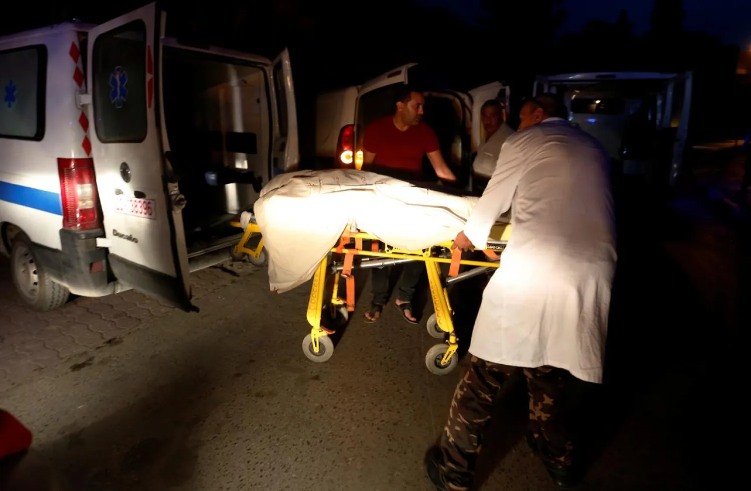 Hospital workers transport the body of member of Tunisian security forces, who was killed in an ambush in the northwest of the country close to the border with Algeria, at a hospital morgue in Tunis, Tunisia, July 8, 2018. REUTERS/Zoubeir Souissi