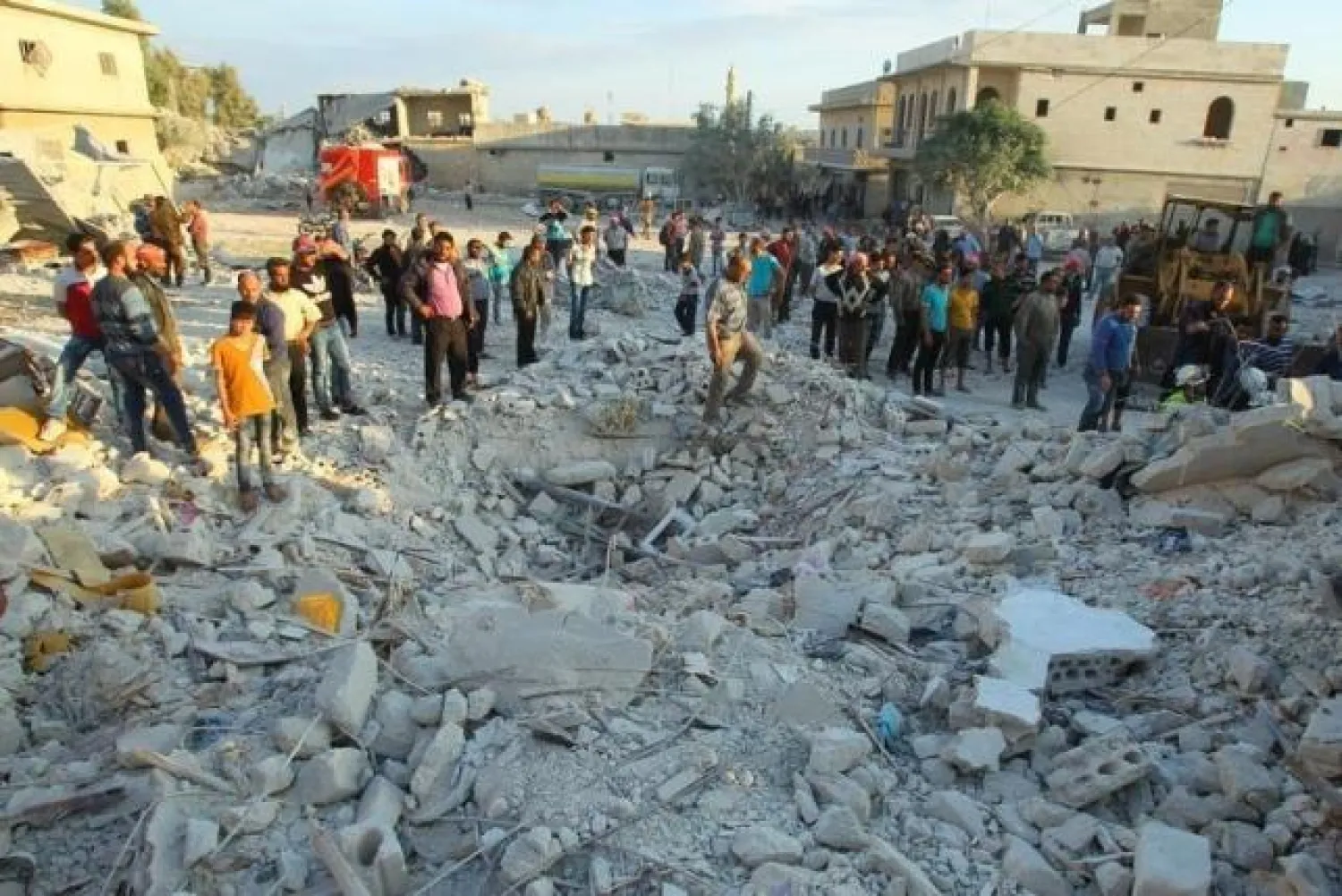 Residents inspect a site damaged by an airstrike in Hafsarja, in the rebels stronghold of Idlib province, Syria May 9, 2016. REUTERS/Ammar Abdullah

