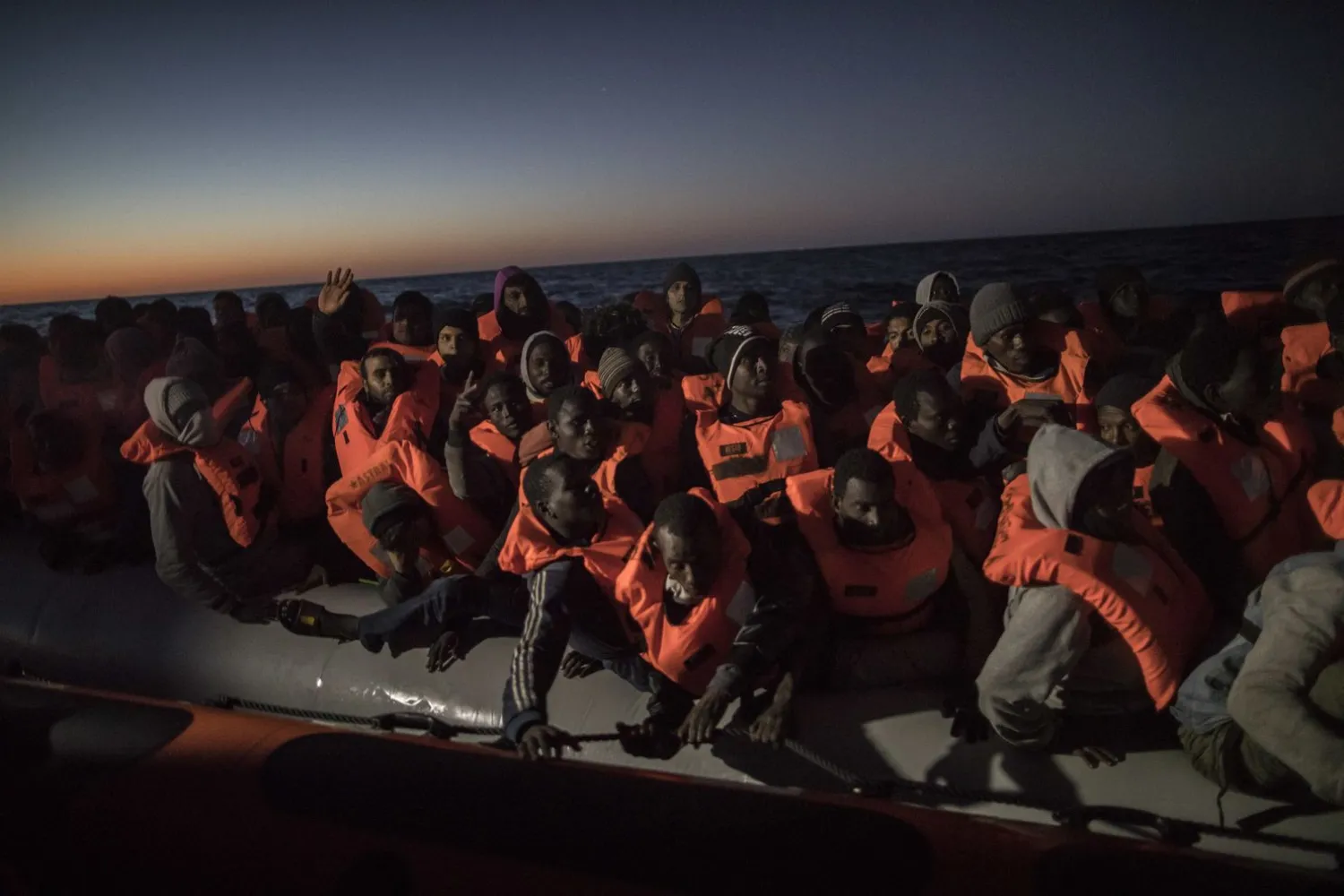  In this Jan. 16, 2018 file photo, Sub-Saharan refugees and migrants from different nationalities trying to leave the Libyan coast and reach European soil aboard an overcrowded rubber boat are rescued by a team of aid workers from the Spanish NGO Proactiva Open Arms, 28 miles north of Al Khums, Libya. (AP Photo/Santi Palacios, File)