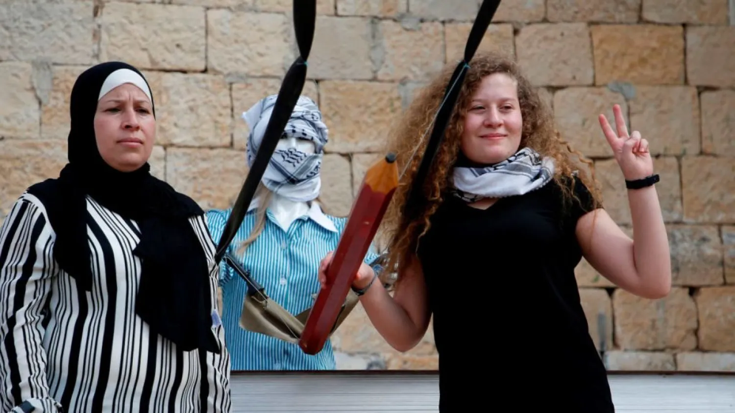 Ahed al-Tamimi posing for a picture with her mother Nariman after a press conference in the West Bank village of Nabi Saleh in July. (AFP)
