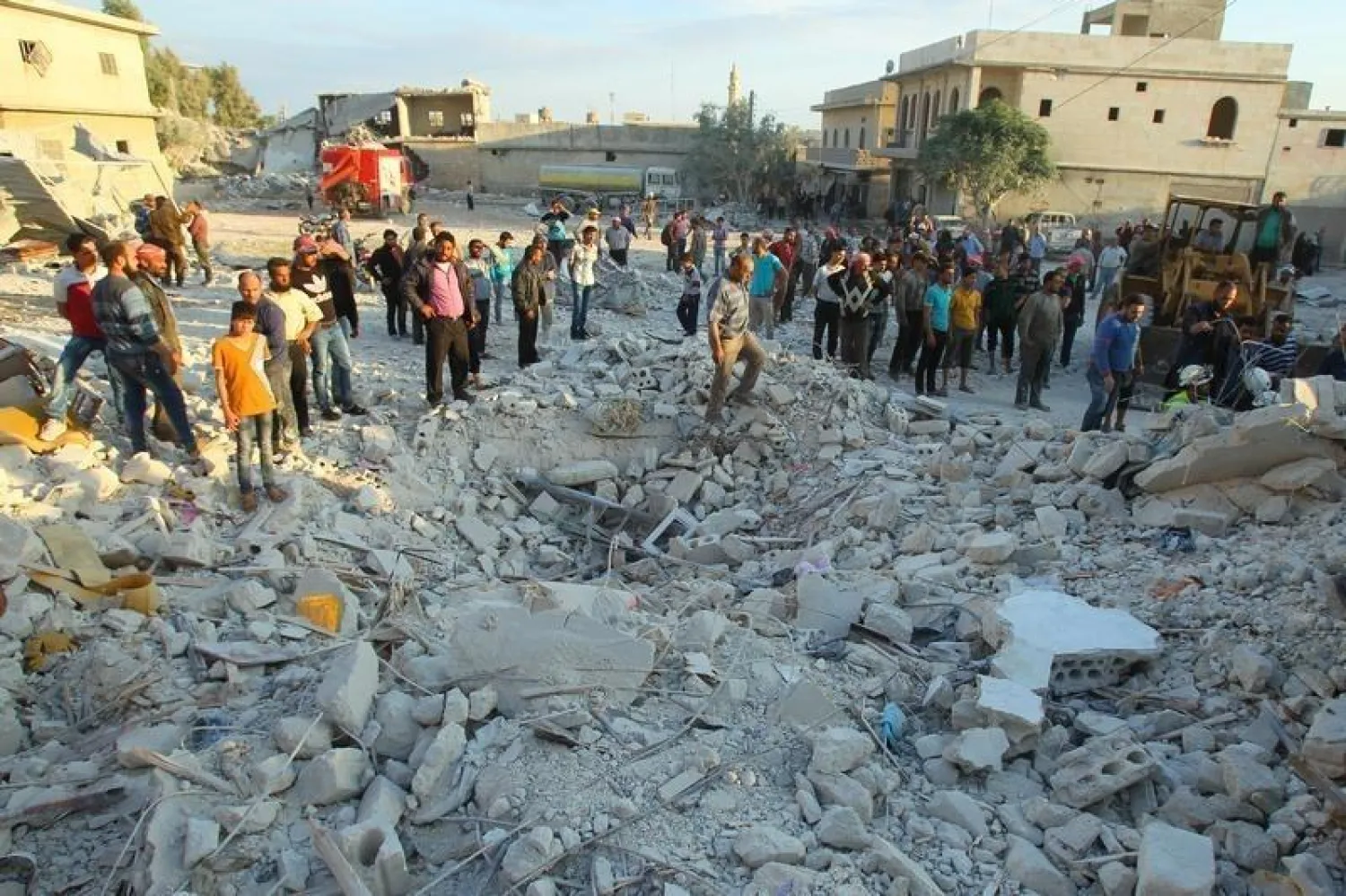 Residents inspect a site damaged by an airstrike in Hafsarja, in the insurgent stronghold of Idlib province, Syria May 9, 2016. REUTERS/Ammar Abdullah