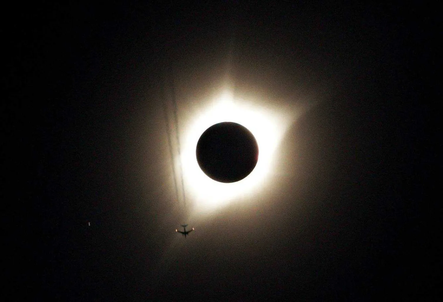 A jet plane flies by the total solar eclipse in Guernsey, Wyoming. REUTERS