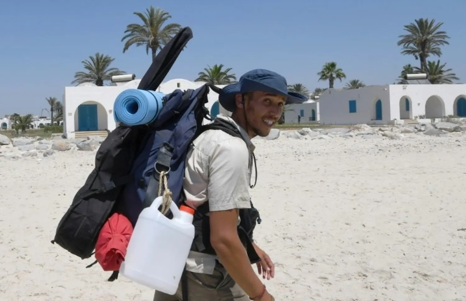 Houij hopes his two-month trek will help convince authorities, holidaymakers and average Tunisians that the sea should not be used as a giant garbage tip. (AFP)
