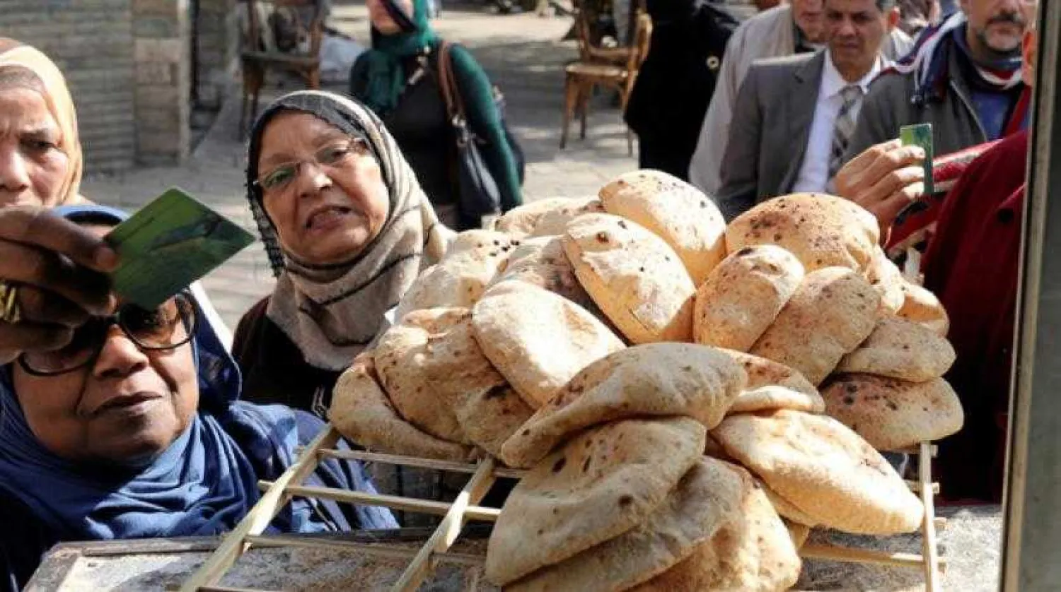 Egyptians buy bread from a street bakery in Cairo (Reuters)