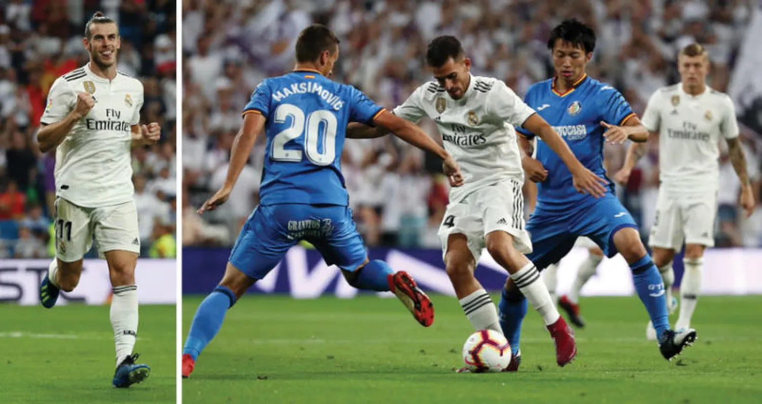 لاعب ريـال مدريد داني سيبايوس يحاول المرور من دفاع خيتافي (رويترز)  -  بيل يحتفل بهدف أحرزه بعد أن صنع آخر (رويترز)