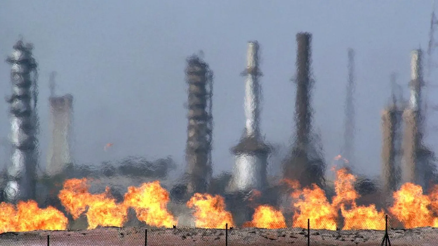 Fires flare off the gas from crude at an oil processing plant in the northern Iraqi town of Baba Gurgur, outside of Kirkuk. (AP)