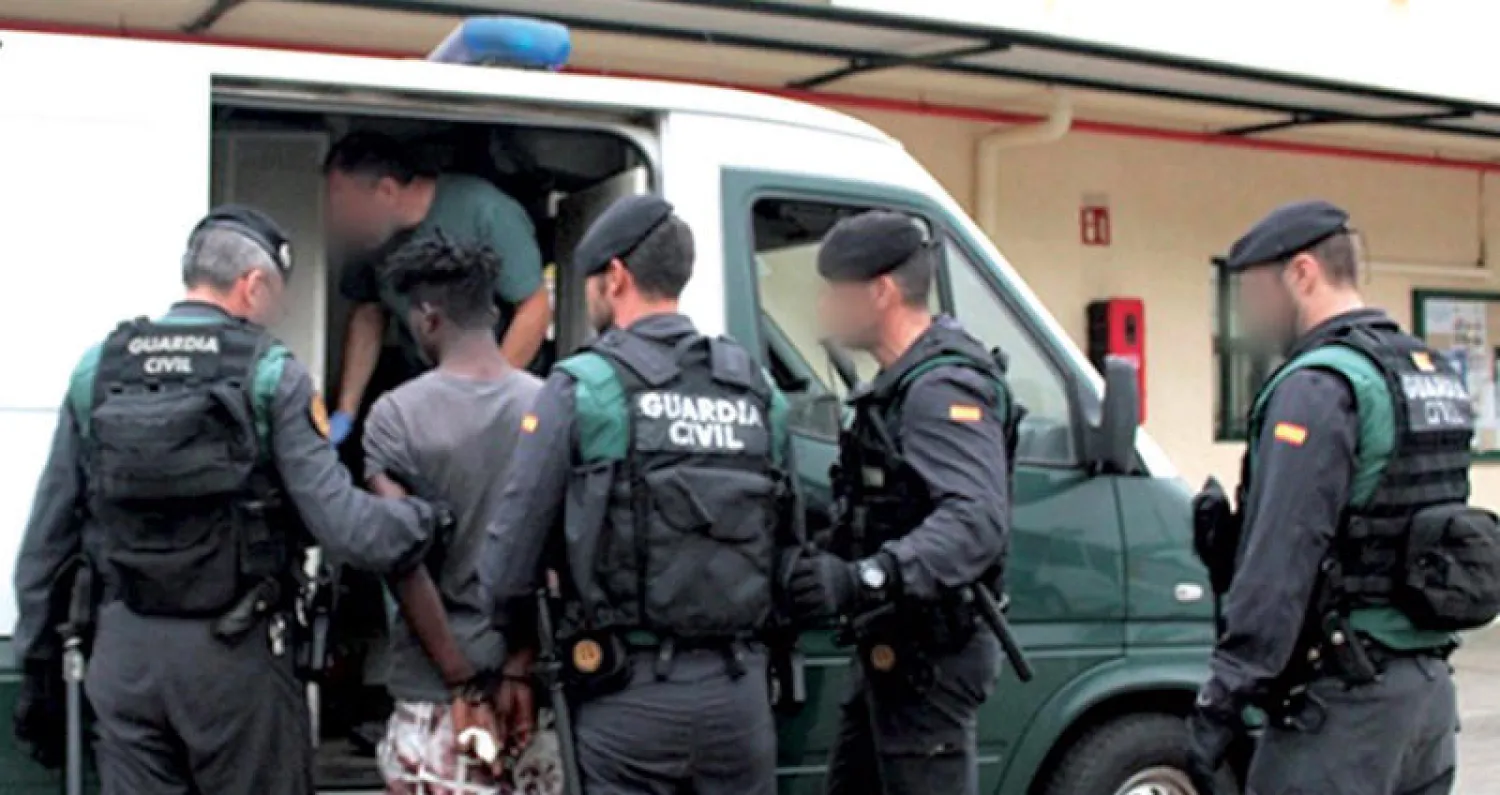 شرطيون إسبان يعتقلون شخصاً خلال حملة ضد مهاجرين في جيب سبتة أمس (أ.ف.ب)