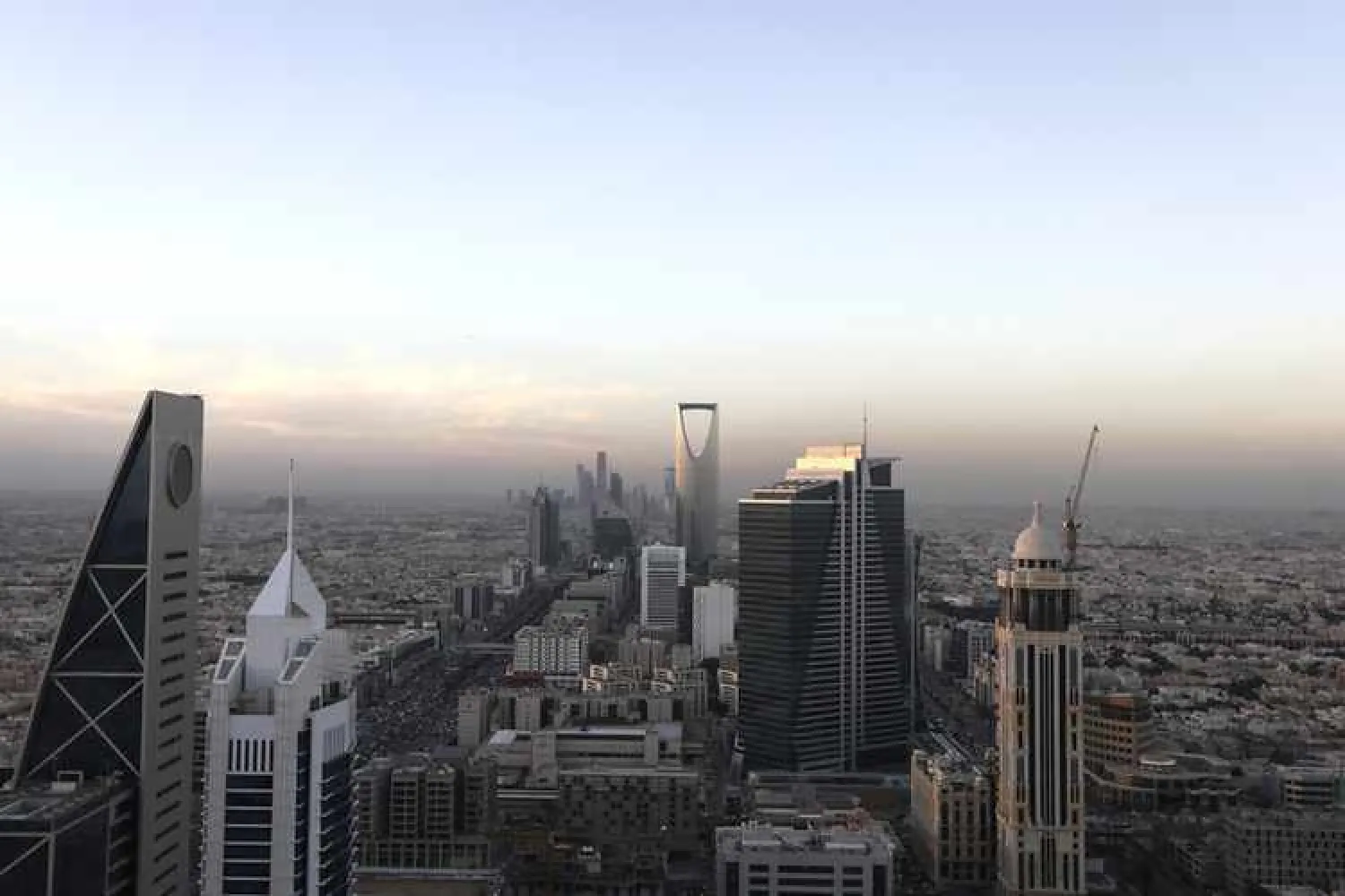Buildings stand as automobile traffic moves along the King Fahd highway, left and Olaya Street, right, in Riyadh, Saudi Arabia. | REUTERS