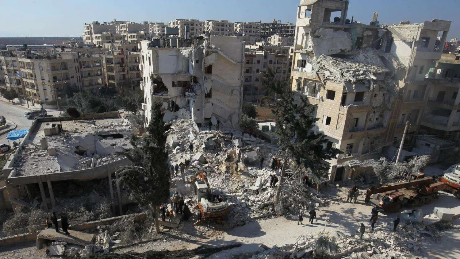People inspect the damage at a site hit by airstrikes in Idlib, Syria. (Reuters)