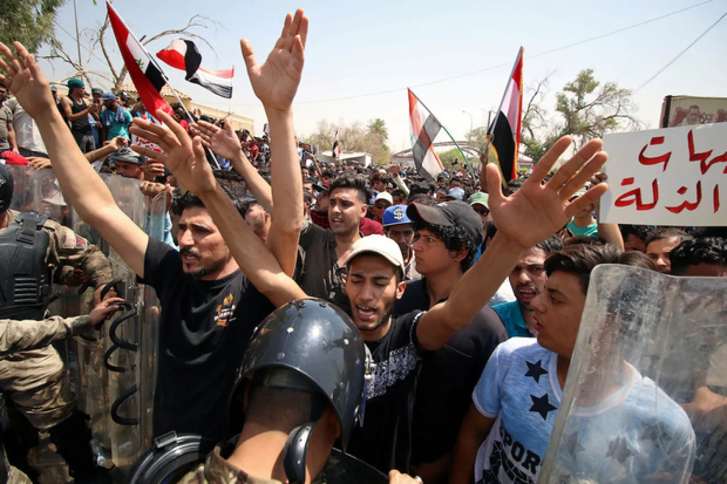 People shout slogans during a protest near the main provincial government building in Basra (Reuters)