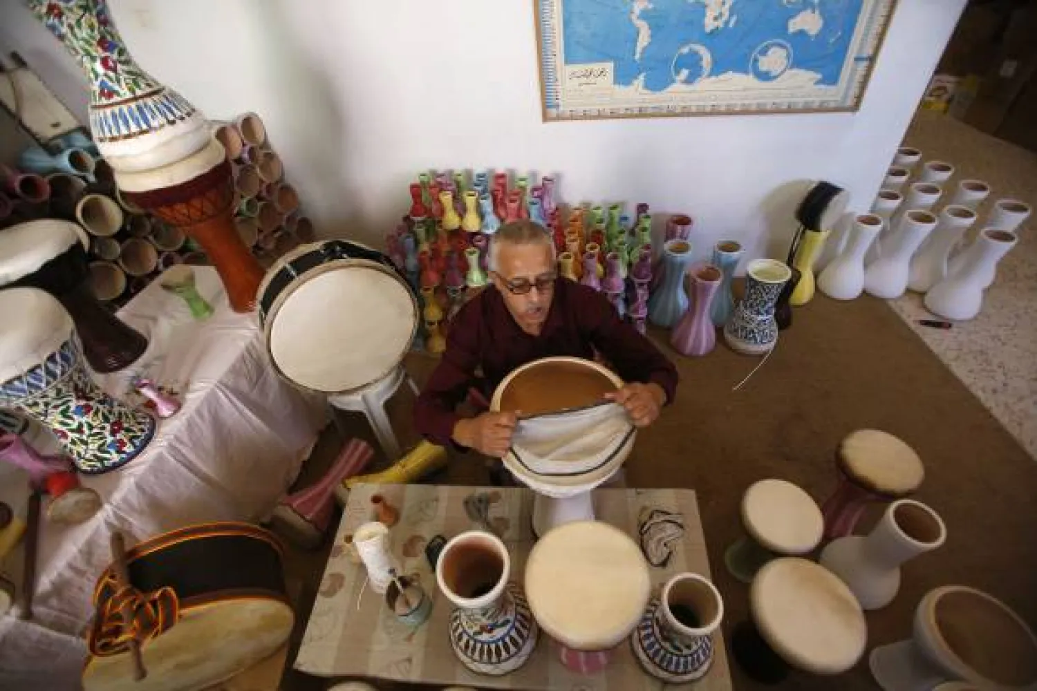 Palestnian artisan Ayoub al-Zaatari works at his workshop where he produces various kinds of hand-made drums and musical instruments, using clay, wood and leather in the southern West Bank city of Hebron on August 14, 2018. Getty Images
