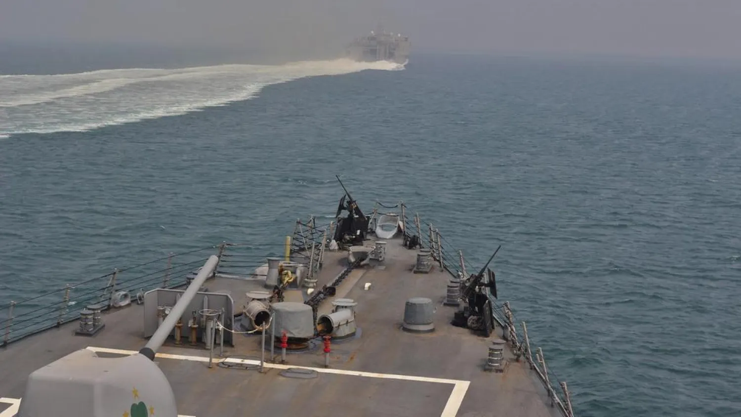 The US naval vessels transit through the Strait of Hormuz. (Reuters)