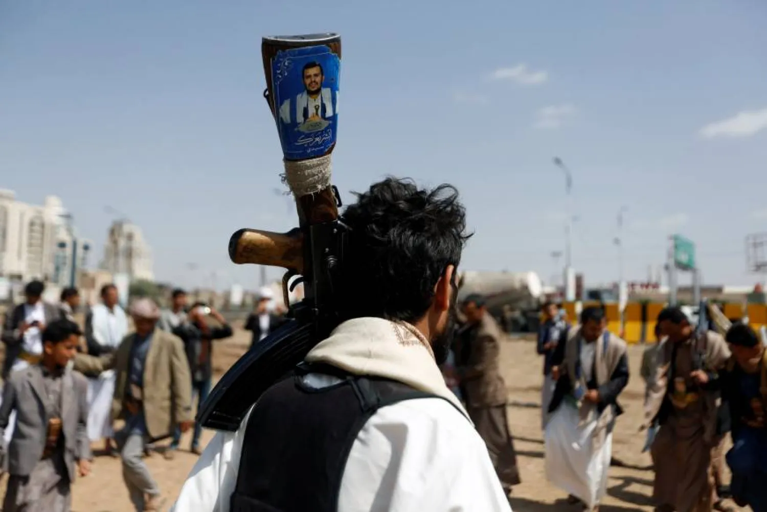 A Houthi supporter holds a rifle with an image of the militias’ leader, Abdulmalik al-Houthi, in Sanaa. (Reuters)