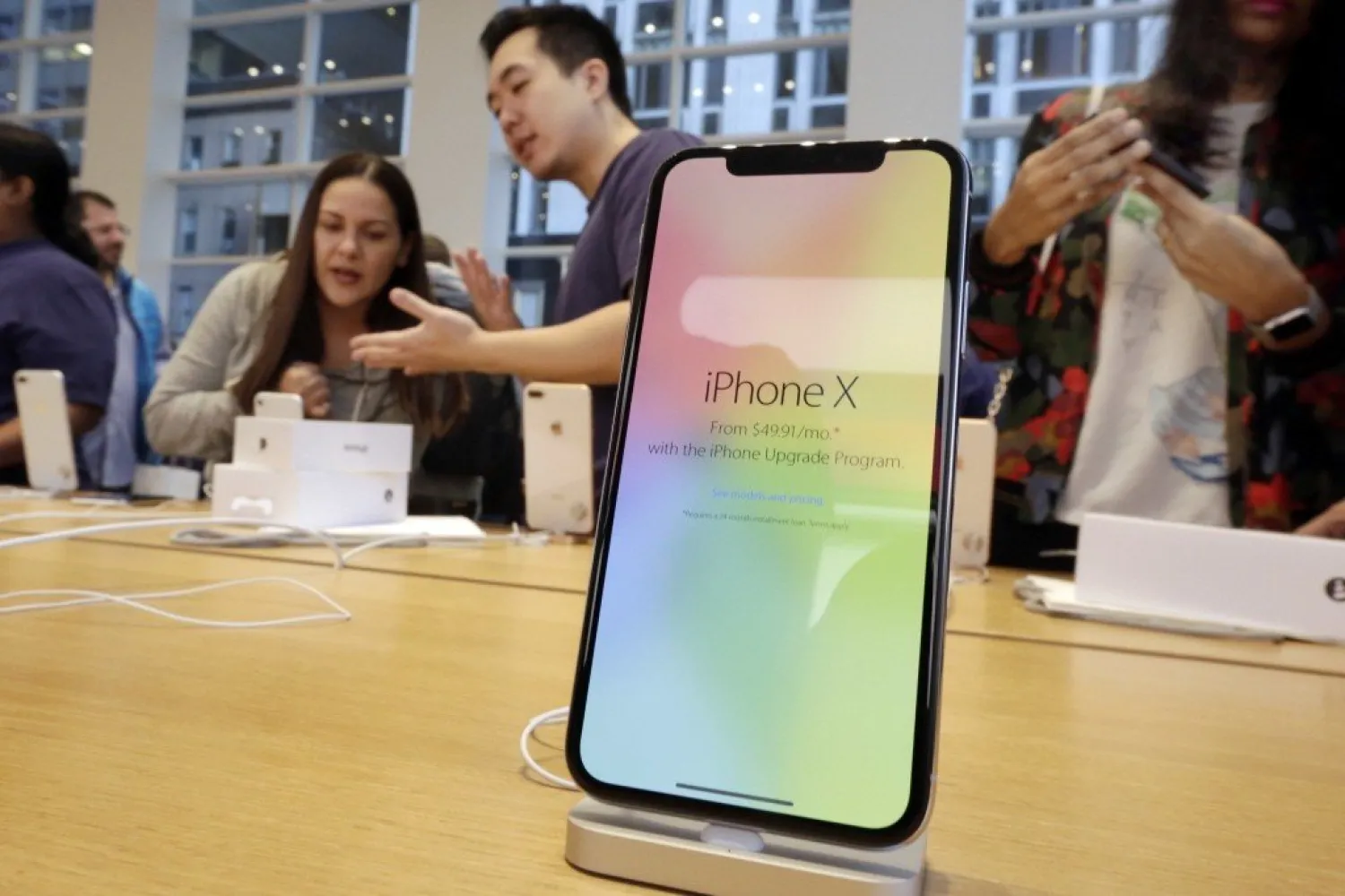  In this Nov. 3, 2017, file photo, customers buy the iPhone X at the Apple Store on New York's Fifth Avenue. Apple is expected to unveil its biggest and most expensive iPhone on Wednesday, Sept. 12, 2018, as part of a lineup of three new models aimed at widening the product's appeal amid slowing sales growth. (AP Photo/Richard Drew, File)