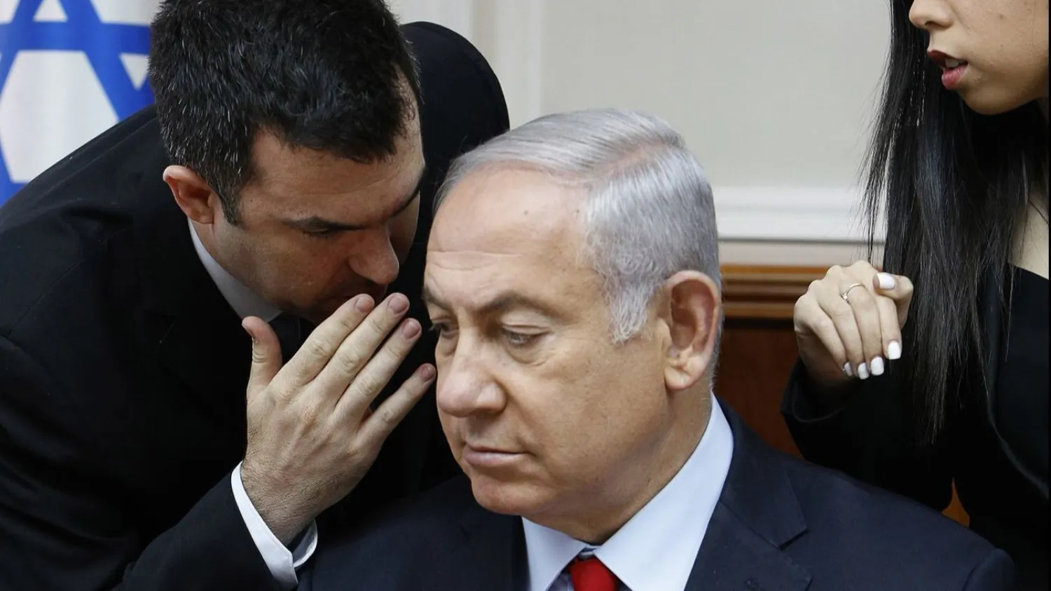 Spokesman David Keyes, left, leans in to speak to Israeli Prime Minister Benjamin Netanyahu in a July meeting of the Cabinet. (Gali Tibbon / Associated Press)
