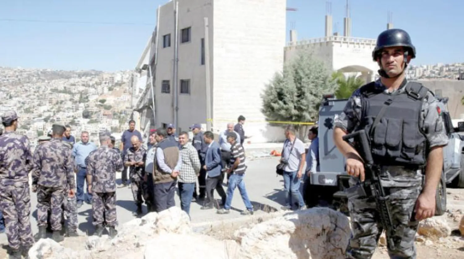 Security forces gather near a damaged building at the city of Salt, Jordan, August 12, 2018. REUTERS/Muhammad Hamed