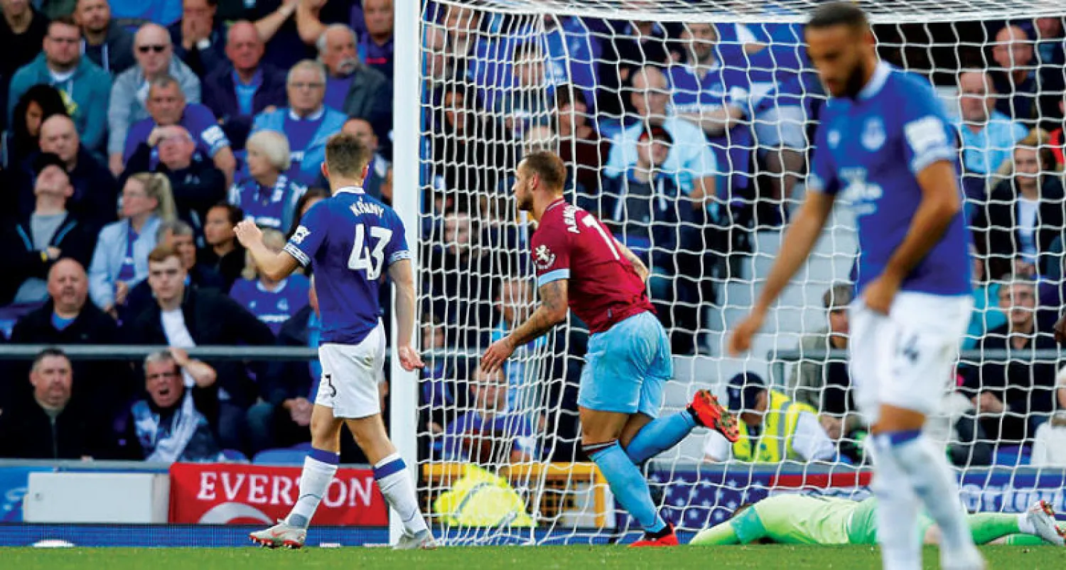 أرناؤتوفيتش نجم وستهام (في المنتصف) يحتفل بتسجيله ثالث أهداف فريقه بمرمى إيفرتون (رويترز)