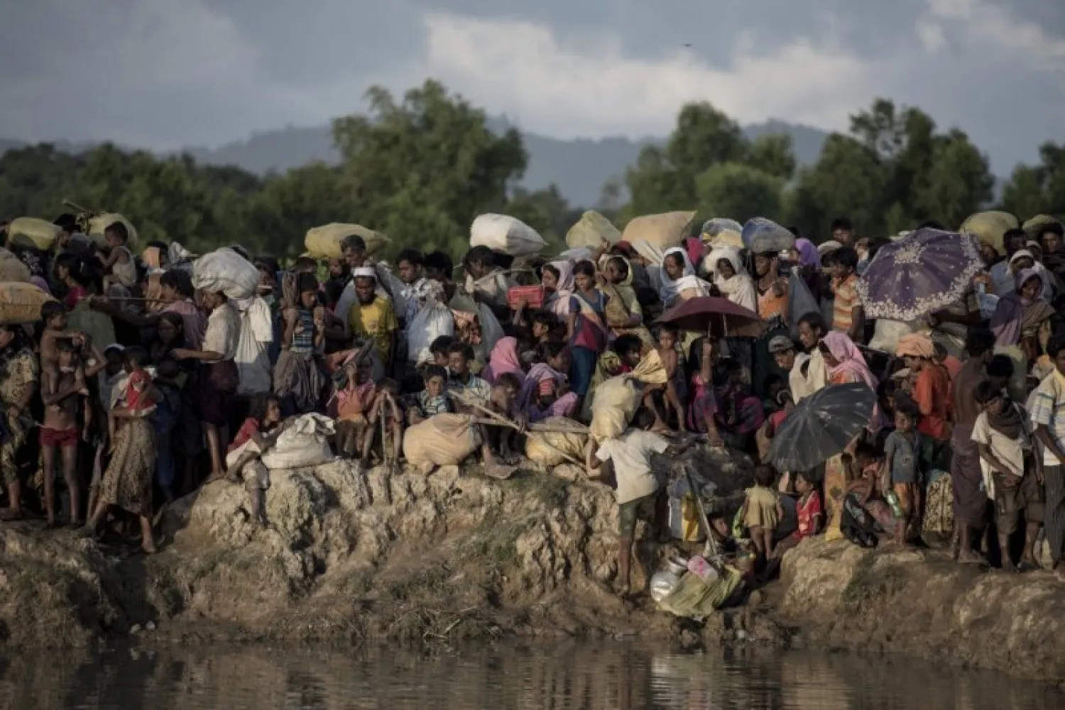 This file photo taken on October 10, 2017, shows Rohingya refugees fleeing from Myanmar arrive at the Naf river in Whaikyang, Bangladesh border— AFP

